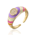Macro shot of 18K gold plated ring with colorful enamel inlay and sparkling CZ zircon gems - Multicolor