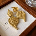 Vintage golden tiered leaf earrings with hammered texture on canvas display - Pleated Heart Style (26#)