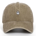 Close-up of ghost embroidery detail on a vintage washed cotton baseball cap in khaki - Khaki