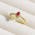 Macro shot of gold ring featuring marquise red gemstone with sparkling diamond halo - Red Marquise Stone Cluster Style (款式11)