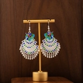 Detail of peacock enamel earrings with silver-finish bells on a golden display stand - Silver Enamel Tassel Peacock