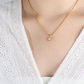 Golden bead chain necklace with round light blue gemstone pendant on a model - Gold / Light Green (P1432-40+5cm)