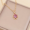 Macro detail of gold flower pendant with pink oval stone and white crystal accents - Light Purple