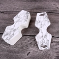 Macro detail of white marble pattern jewelry display cards on a wooden surface - Marble Pattern