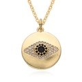 Macro shot of 18K gold evil eye coin pendant with black and white zircon stone inlay - Round Coin Style (D181)