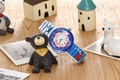 Detail of waterproof kids watch with colorful dial on a desk with wooden toys - Ocean