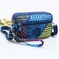 Blue geometric crossbody phone bag for women with adjustable strap and sport logo - Colorful Polka Dots