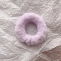 Macro shot of soft lavender faux rabbit fur scrunchie with elastic hair band texture - Purple