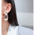 Polished silver teardrop earrings on model showing large metallic drop style - Platinum Large