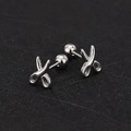 Close-up of silver scissors-shaped studs with secure screw-back ball closure - Scissors / Steel