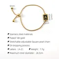 Detail showing adjustable 18K gold plated bracelet dimensions and black enamel A pendant - A-Black