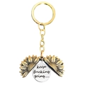 Dettaglio del portachiavi a girasole dorato apribile con ciondolo inciso e frase ispiratrice - T00002 Girasole Oro Disco Argento (Keep fucking going)