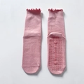 Pink yoga grip socks with ruffled cuffs and non-slip silicone soles in mid-calf length - One Size / Pink