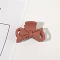 Detailed close-up of matte brick red bow hair claw clip with a sleek frosted resin finish - 4.5cm Bowknot-Orange