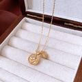 Macro shot of gold starburst necklace with zircon inlay on a wooden jewelry box - Gold
