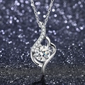 Detail of silver wave pendant featuring a round moissanite in six-prong setting - Q012 Dynamic Curve 1ct