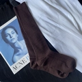 Brown ribbed knit cotton high socks laid flat on textured fabric with fashion magazine - Calf-length Brown