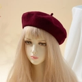 Classic wine red wool blend beret with top stem, shown on a mannequin head profile - One Size / Burgundy