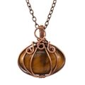 Macro view of handmade wire-wrapped tiger eye stone pendant on bronze necklace chain - Brown (Tiger Eye)