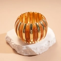 Detail of amber acrylic beads and gold polished metal spacers on an elastic bracelet - Light Coffee