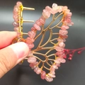 Close-up of golden butterfly hair claw clip with pink natural crystal gravel stones - Strawberry Quartz Gold Butterfly