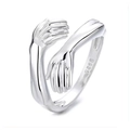 Sterling silver hugging hands ring featuring an adjustable open band and a polished finish - Style 007 / Silver
