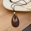 Detail of water drop wood pendant with textured bronze metal inlay on wax cord - Wooden Waterdrop Nesting Style (HN9839-HN9840)