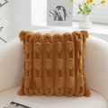 Ginger yellow plush square pillow with 3D geometric texture and tassels on a sofa - Brown
