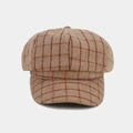 Close-up of brown plaid newsboy cap showing thick wool texture and vintage stitching - Camel