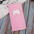 Pink greeting card with 3D white angel wings and motivational text on wooden surface - 3D Wings / Pink