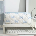 Close-up of quilted pencil case with blue bow patterns on a clean workspace desk - White Background Blue Bow
