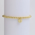 Detail of golden beaded bracelet featuring a round pendant engraved with letter T - Letter T (DB240603-T)