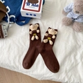 Brown crew socks with cute 3D plush teddy bear charm on white fabric background - One Size / Brown