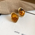 Macro shot of irregular amber stud earrings with elegant gold metal edges on textured paper - 80# Silver Earring Post-Brown-Irregular Amber Gold Bound