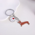 Detailed view of metal dachshund keychain with I Love Dogs charm and paw print detail - Slender Dachshund + Heart