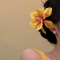 Yellow flower hair clip worn by model for elegant seaside bridal headpiece style - Yellow Magnolia Hair Clip
