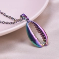 Close-up of rainbow metal cowrie shell pendant necklace on soft pink silk background - Rainbow Color Necklace