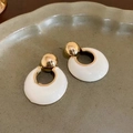 Close-up of pearl flower earrings with gold plating and white enamel on a ceramic tray - No. 61 Silver Needle Earrings - Gold - Cream Hoop