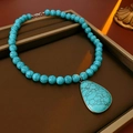 Vintage style turquoise beaded necklace with large teardrop pendant on brown display - 14# Necklace - Blue Water Drop Turquoise