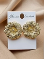 Close-up of golden floral earrings with detailed texture on elegant silk background - Gold Flower Stud Earrings