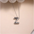 Macro shot of silver 3D balloon-style letter Z pendant on a delicate box chain - Silver (With Necklace) Z