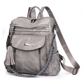 Grey PU leather backpack featuring woven straps and elegant side tassel detail - Gray