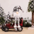 Grey knitted gnome plush with white snowflakes sitting on a red vintage toy car - Long Leg with LED / Gray