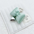 Light green fabric bow keychain with silver heart pendant and heart-shaped clasp - Green