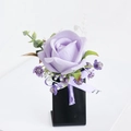 Light purple faux rose boutonniere with green leaves and ribbon on black stand - Corsage / Light Purple