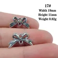 Detailed view of silver bow-shaped connectors for jewelry DIY showing exact dimensions - No.17/Bowknot