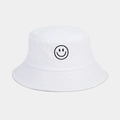 Close-up of a white cotton bucket hat with a black embroidered smiley face detail - One Size / White