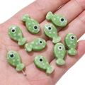 Light green ceramic fish bead with white polka dots for DIY jewelry making - Green