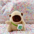 Plush capybara keychain with green 'Fa' crossbody bag on colorful foam balls background - Light Brown Green Fortune + Bead Chain