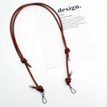 Detail of adjustable brown leather shoulder strap with silver metal buckle on white surface - Silver Plate Hook / Dark Brown